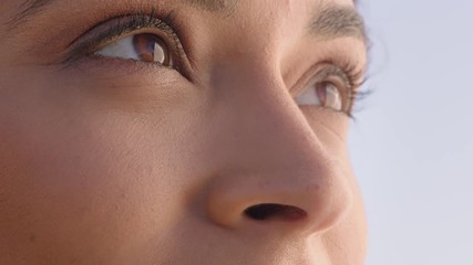 close up beautiful eyes hispanic woman looking at ocean view enjoying natural beauty contemplating future enjoying freedom