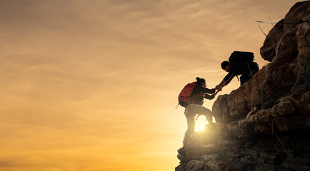 Asia couple hiking help each other silhouette in mountains with sunlight. - 245462968