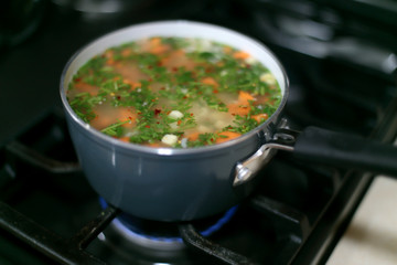 Pot of vegetable soup cooking on the stove.