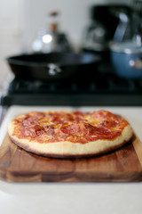 Freshly baked homemade pepperoni pizza in cast iron pan from the oven.
