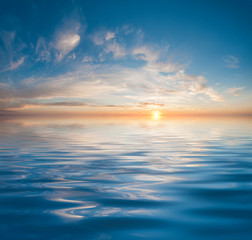 Sunset or sunrise over calm water