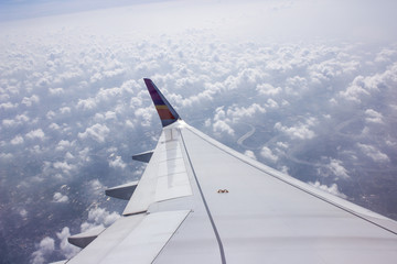 Wing of the plane on sky background