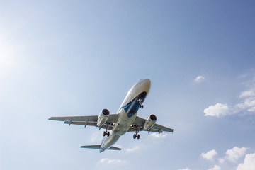 Fototapeta na wymiar The aircraft flying on blue sky background