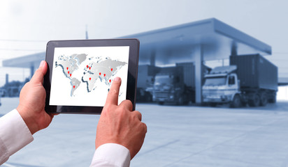 transportation import export concept,Man hand holding cell phone or tablet  automate wireless for control drlivery shipment