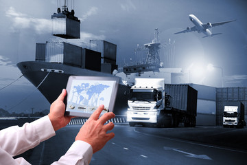 Transportation import export concept,Man hand holding cell phone or tablet  automate wireless for control drlivery shipment - obrazy, fototapety, plakaty