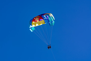 Sea and beach sport for tourists, parasailing in blue sky
