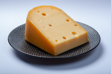 One piece of traditional Dutch old hard cheese made from cow milk