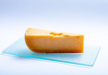 One piece of traditional Dutch very old hard cheese made from cow milk