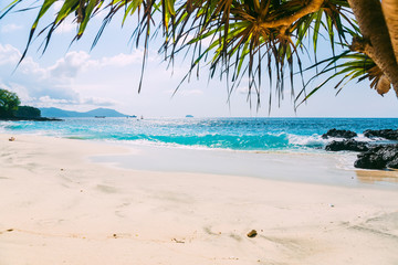 Fototapeta na wymiar Tropical beach with sand and blue ocean wave in island