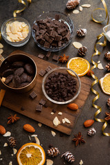 Obraz na płótnie Canvas chocolates, ingredients on black table 
