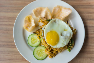 delicious fried rice and fried egg on the top serve on plate