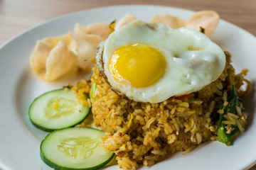 delicious fried rice and fried egg on the top serve on plate