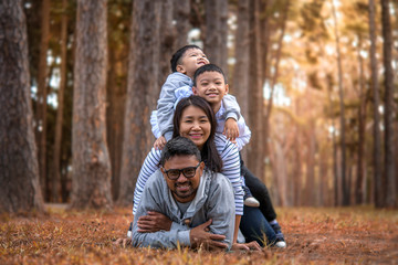 Fototapeta premium Young family with children having fun in nature