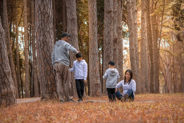 Fototapeta premium Young family with children having fun in nature