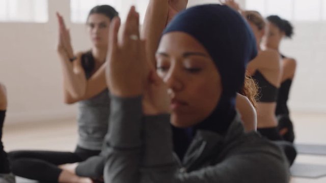 healthy yoga woman practicing eagle pose young caucasian female enjoying fitness lifestyle exercising in studio with group of multiracial women