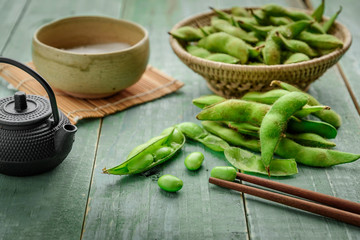 Green Japanese Soybean in wooden bowl on table wood