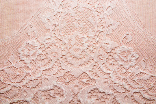 The texture of knitted pink fabric with lace for the background 