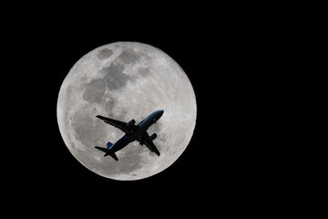 Naklejka na ściany i meble an airplane flying across a full moon, Silhouettes of Aircraft and super moon