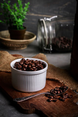Coffee cup and beans on old kitchen table.