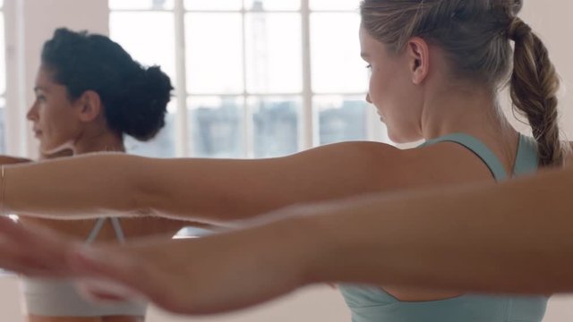 yoga class beautiful caucasian woman practicing reverse warrior pose fitness instructor teaching group of multi ethnic women healthy meditation practice in workout studio