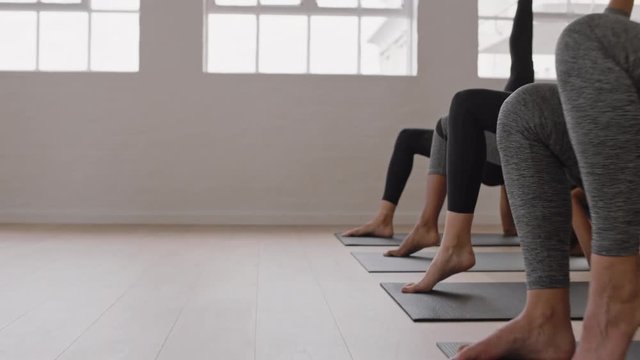 yoga class group of women practicing one legged bridge pose training posture exercising in fitness studio meditation