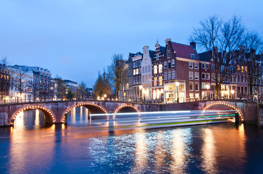 Keizersgracht intersection bridge view of Amsterdam canal and historical houses during twilight time, Netherland.