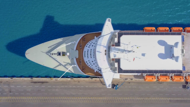 Large cruise ship docked at port - Top down aerial image.