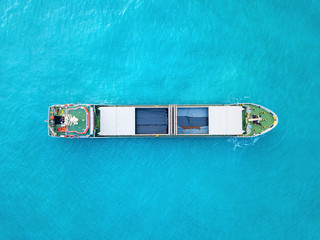 Large Cargo ship loaded with Metal rods anchored at sea - Aerial image