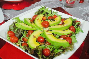 healthy avocado dish, cherry tomatoes, almond lettuce and for romantic dinner