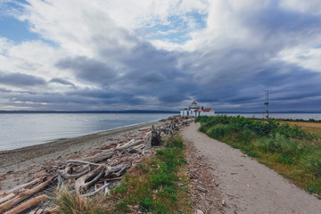 Fototapeta na wymiar Path leading to the Victorian-era lighthouse in Discovery Park, Seattle, USA