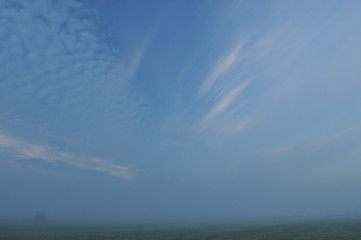 Sky. Dawn, sunrise. Clouds over the meadow.