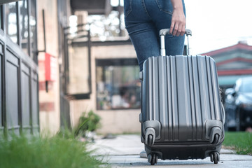 Traveler woman carrying luggage. Tourist walking with Suitcases Travel lifestyle concept.