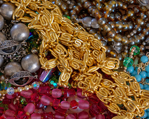 golden and colorful jewerly and pearls top view