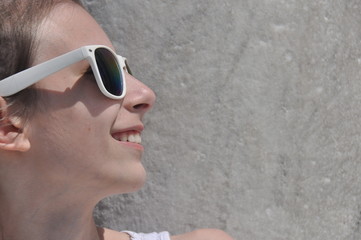 Smiling girl in sunglasses under the Basilica of Pisa