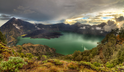 Mount Rinjani (or Gunung Rinjani) landscape at crater rim overlooking into crater lake and its volcanic mountain. Mountain Rinjani is an active volcano in Indonesia on the island of Lombok.
