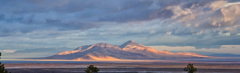 Antelope Island view from Magna, sweeping cloudscape at sunrise with the Great Salt Lake State Park in winter. USA, Utah. © Jeremy