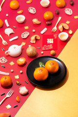 Text appear in image: Prosperity. Flat lay conceptual large group of chinese new year related objects on yellow background.