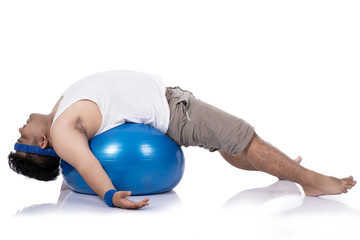 Fototapeta na wymiar portrait of fat young men do pilates with a lying down relaxed