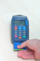 Girl pays purchase through the terminal pos