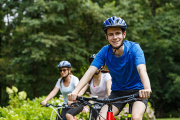 Healthy lifestyle - people riding bicycles in city park