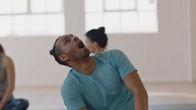 yoga class attractive hispanic man looking bored yawning waiting in fitness studio