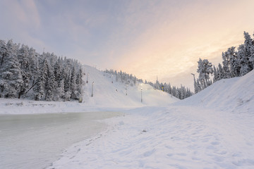 Rukatunturi ski jumping hill in winter season and nice weather and blue sky in winter season and sunset time at Ruka ski Rukatunturi, Finland