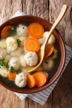 Danish soup with double dumplings and vegetables close-up in a bowl. Vertical top view