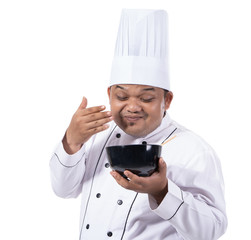 portrait of young chef hold a bowl with smell delicious dish