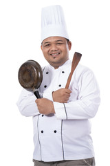 portrait of master chef pose crossed hands with pan and spatula