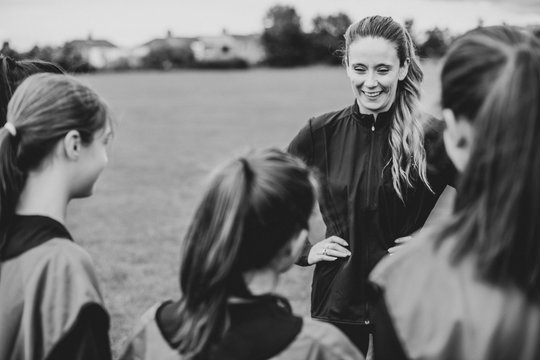Rugby players and their coach gathering before a match
