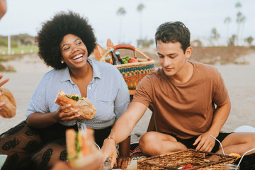 Friends having a summer beach picnic