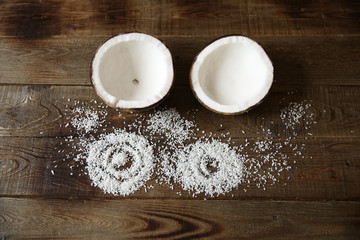 two coconut halves with coconut chips with copy space for text