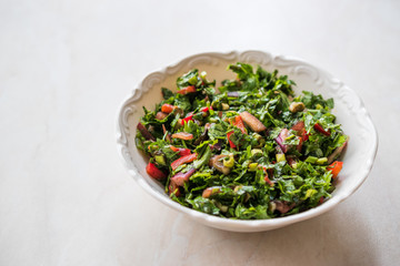 Chopped Parsley Salad with Tomatoes and Onions in Ceramic Bowl on Marble Surface.