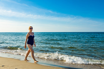 Woman waking on beach